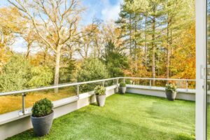Comfortable balcony with artificial grass